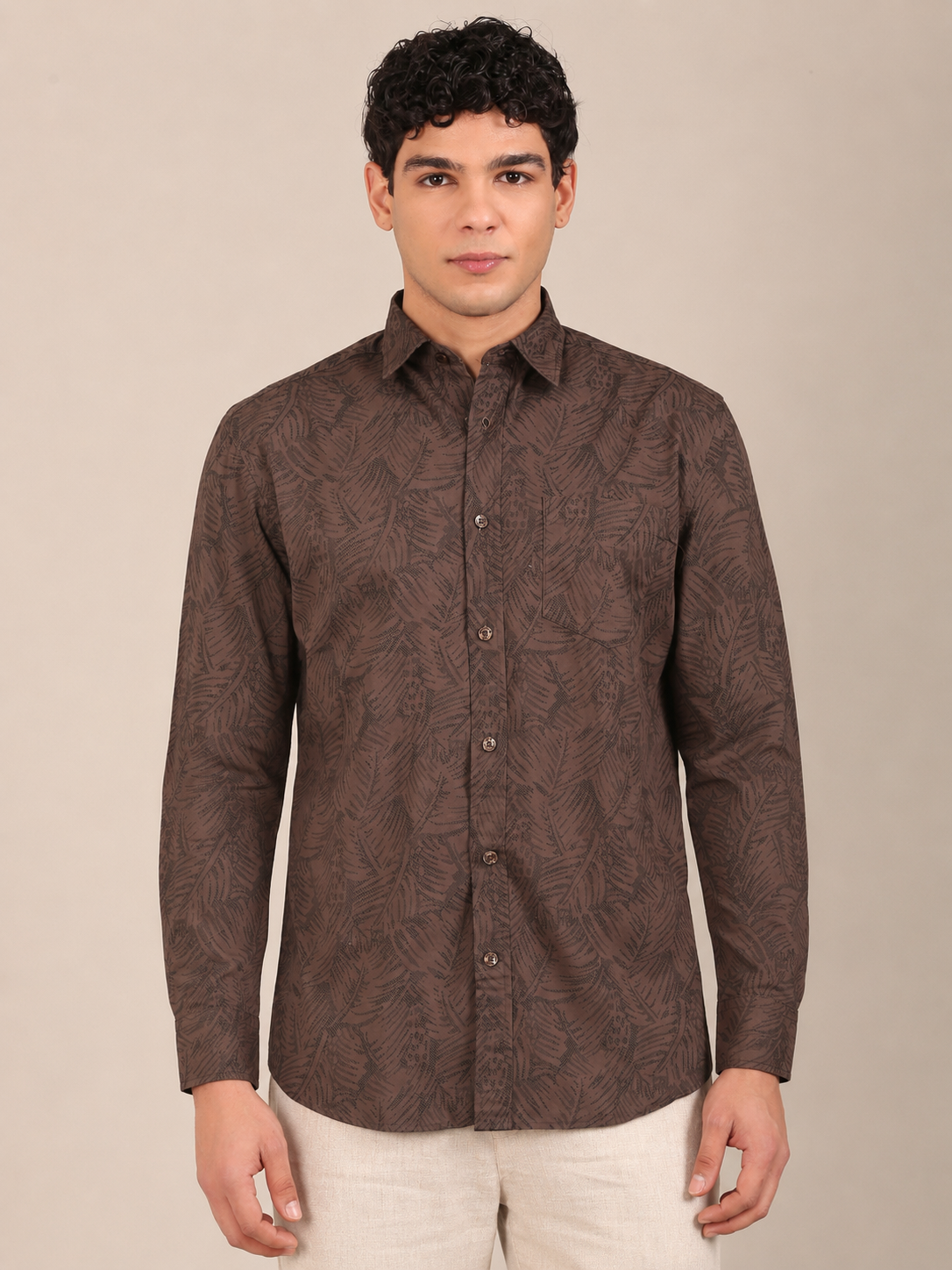 Men’s cocoa brown leaf print shirt styled with beige trousers front-1
